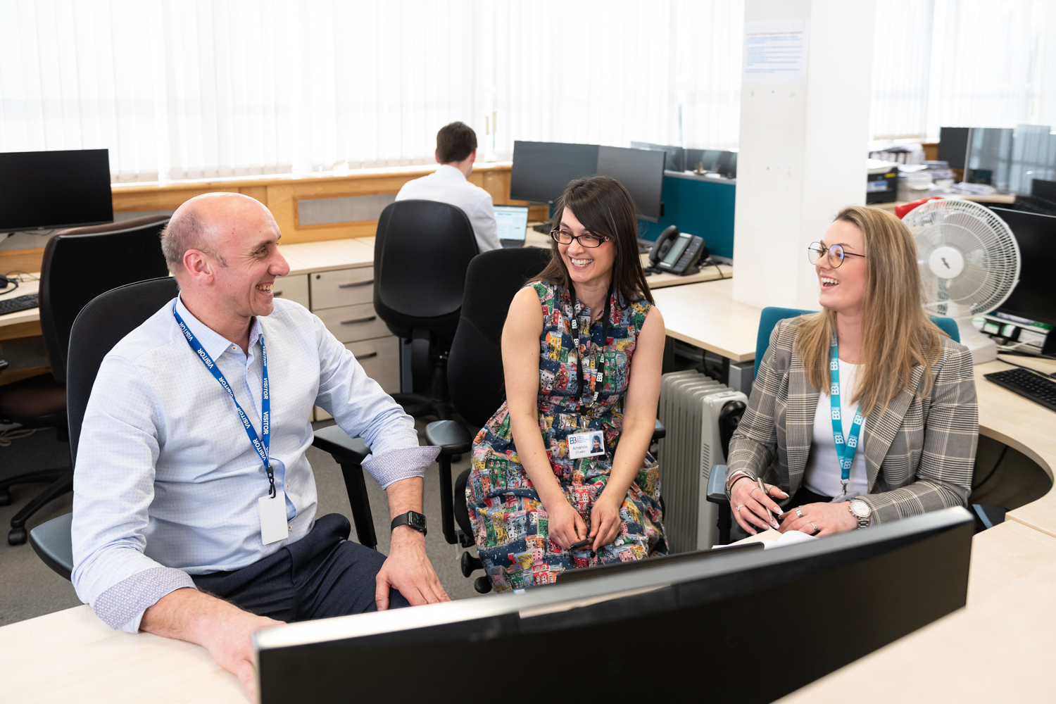 image of team talking in office setting