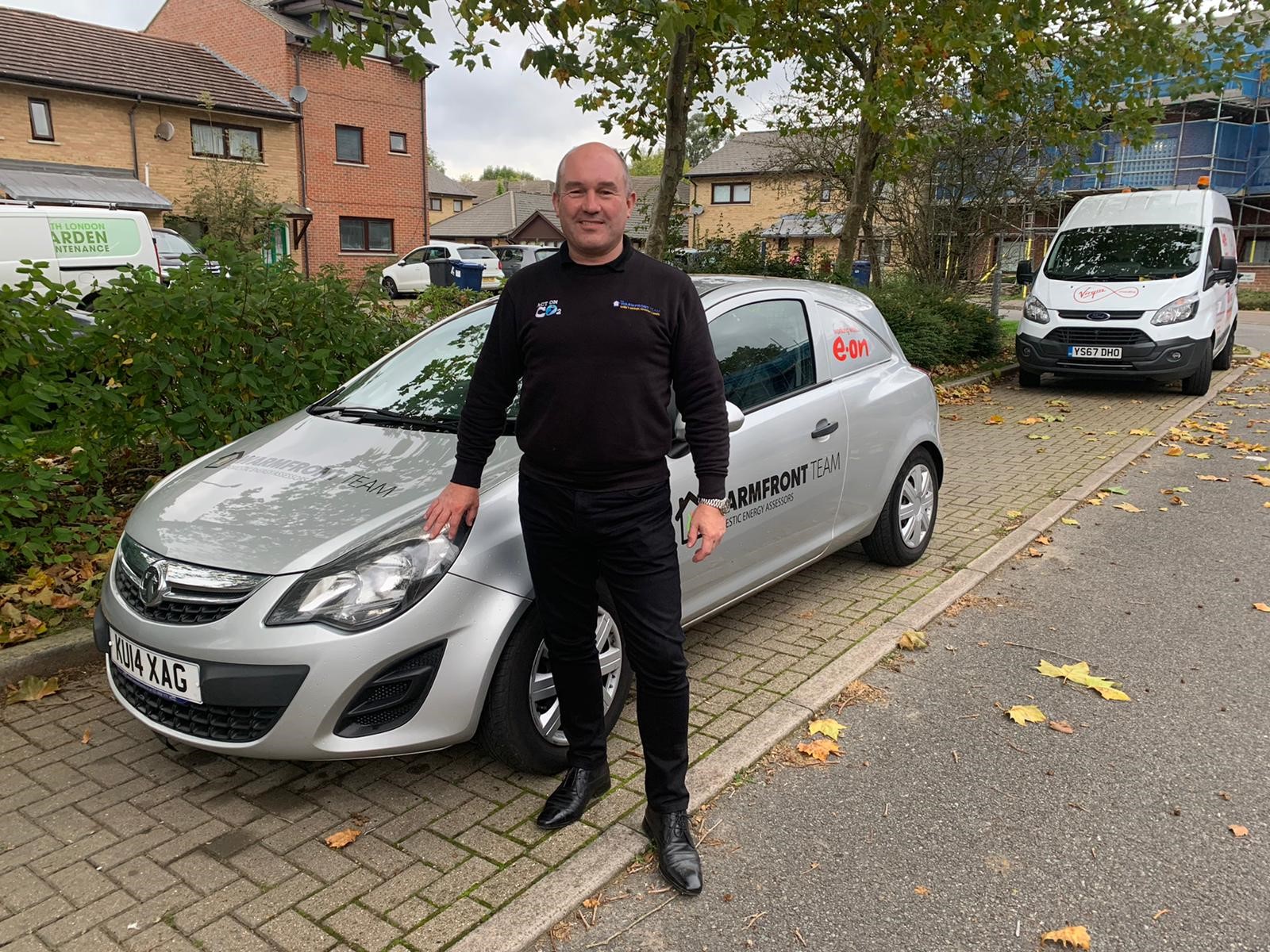 Employee of WarmFront in front of his van