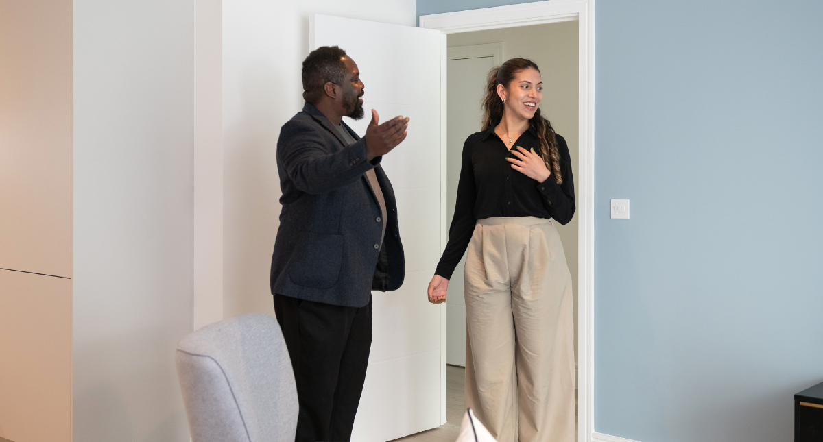 Man showing woman around house