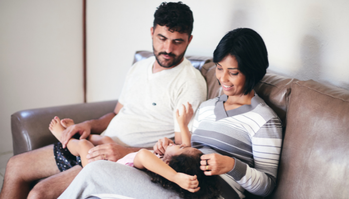young family on sofa