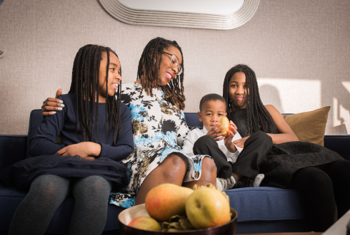 Woman With 3 Children On Sofa
