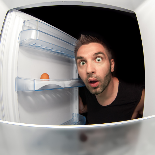 Man looking into fridge