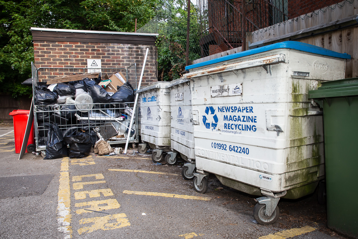 Waste dumped outside bins in alleyway